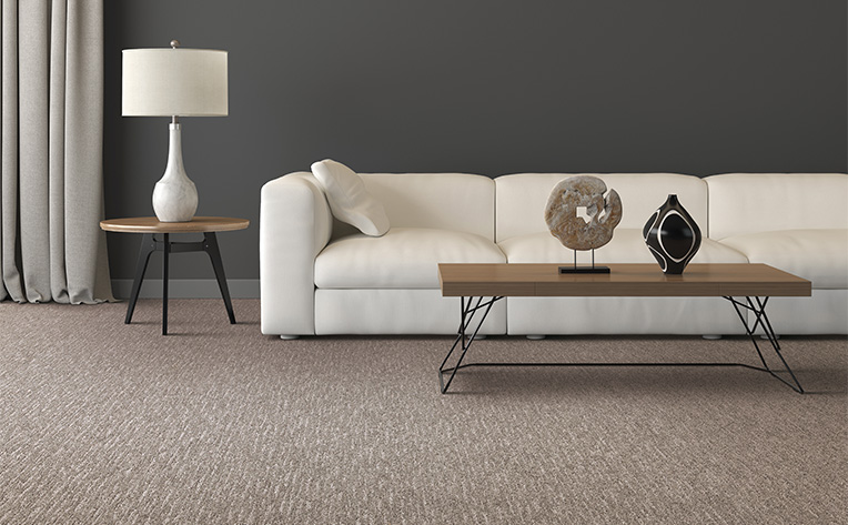 carpet living room with brown table and grey walls